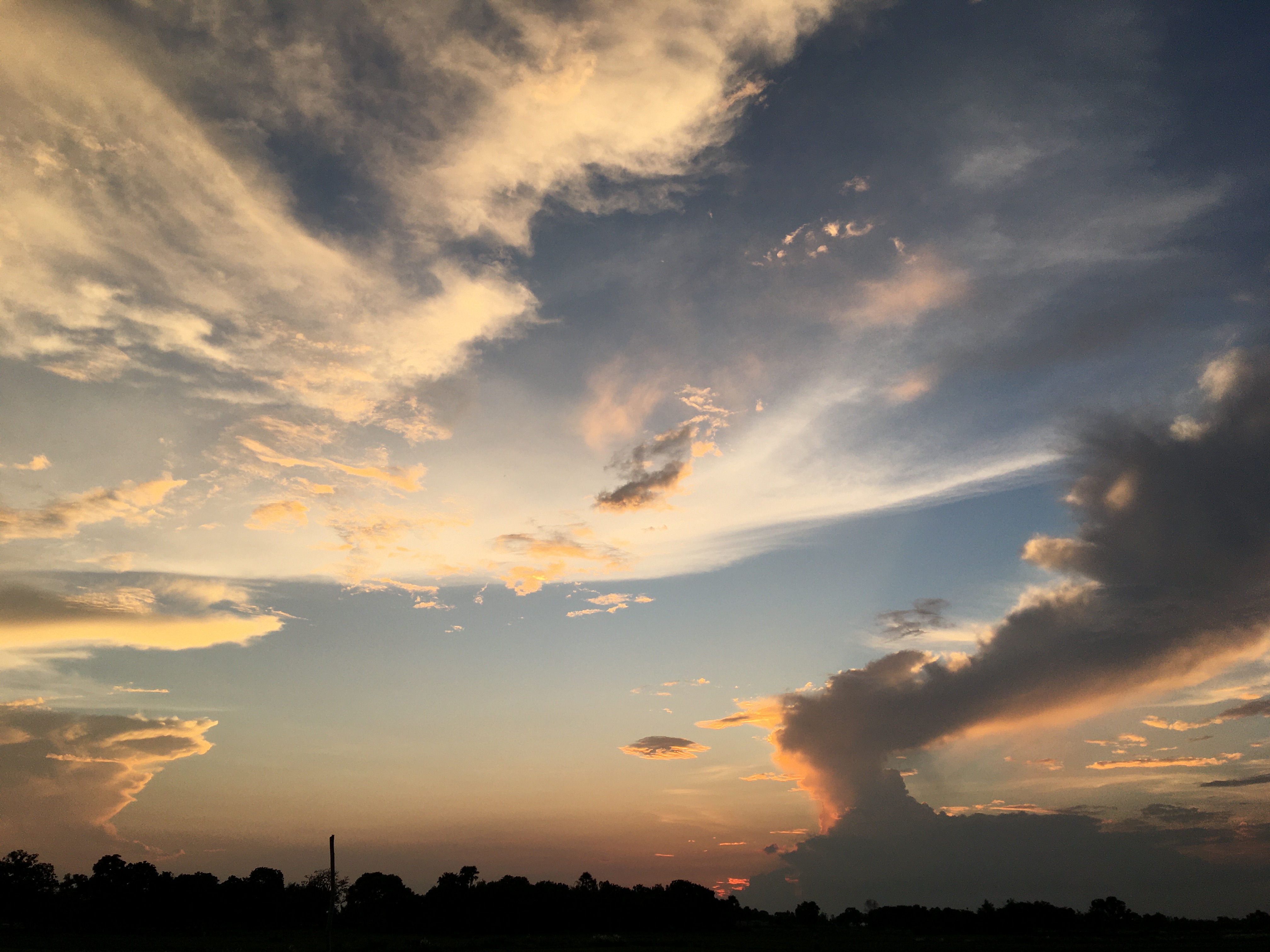 Golden-orange clouds dramatic against a blue sunset sky